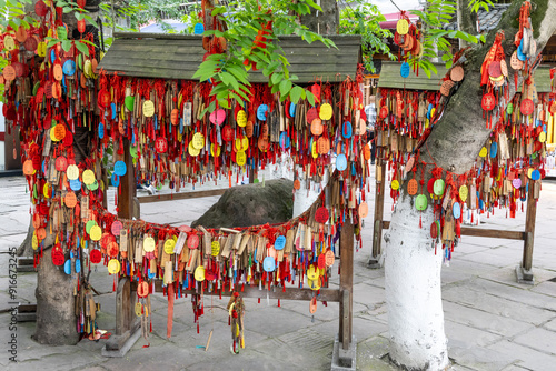 Popular bodhi wishing tree in Huanglongzi ancient town in Sichuan China with thousand of wishes hung up by tourists. photo