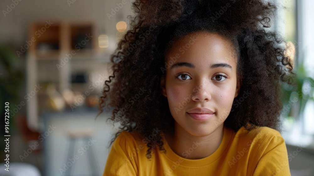 A woman with curly hair is smiling at the camera A woman with curly hair is smiling at the camera