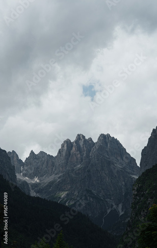 Rocky peaks of the Italian Dolomites surrounded by clouds before a storm.