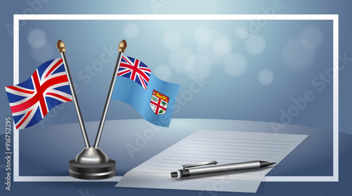United Kingdom and Fiji Small national flag on bokeh background, cooperative relationship
