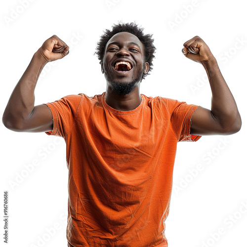 A man in an orange shirt is smiling and raising his arms in the air. Concept of joy and excitement photo