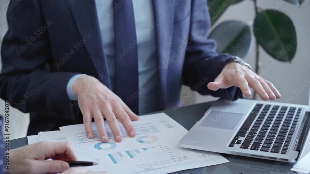 Two professionals analyzing a pie chart during a strategic business meeting. Business meeting with graph analysis Two professionals analyzing a pie chart during a strategic business meeting. Business meeting with graph analysis