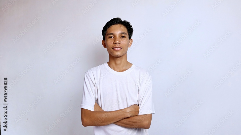Obraz premium Handsome Asian young man smiling posing crossing both arms on chest