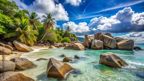 Sunny day on a picturesque Seychelles island coastline with massive stones scattered on the sandy beach and crystal-clear waters.