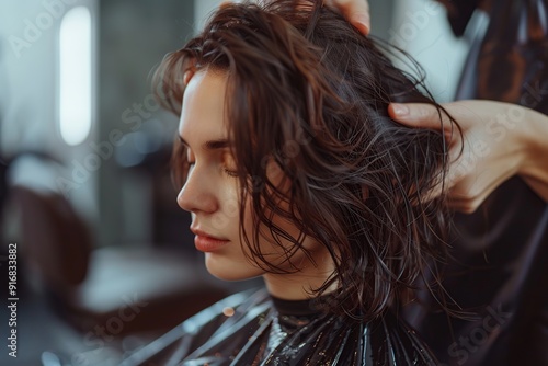 Hairdresser making hairstyle for young woman in beauty hair salon