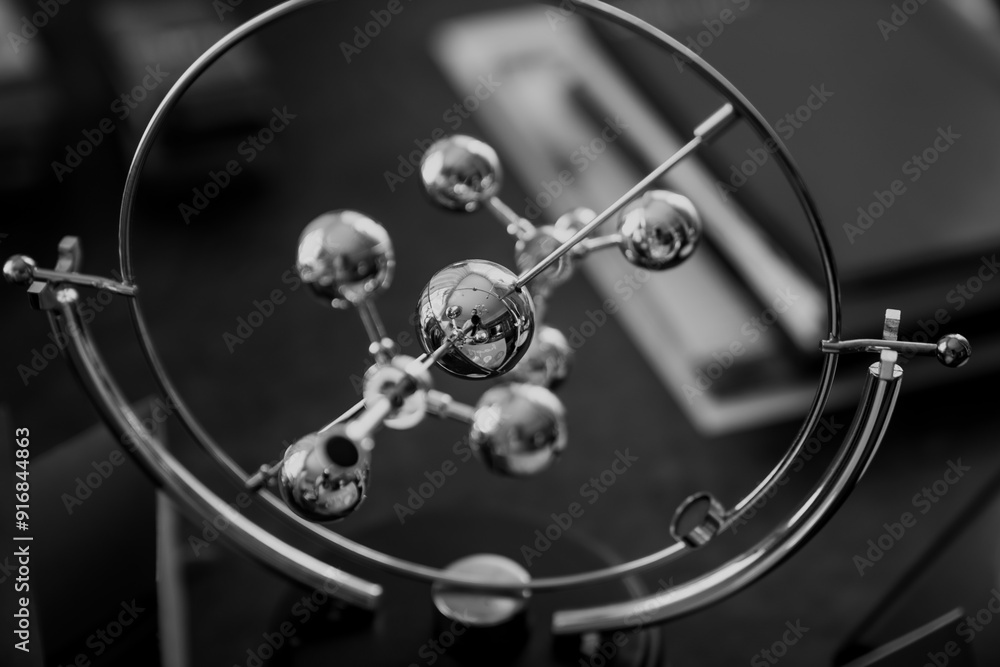 Mechanical atomic desk toy for businessman close up Mechanical atomic desk toy for businessman close up