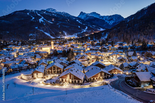 Panoramic view from above at nightfall of the snowy village of Bardonecchia, a ski resort in the Alps in Piedmont, Italy.