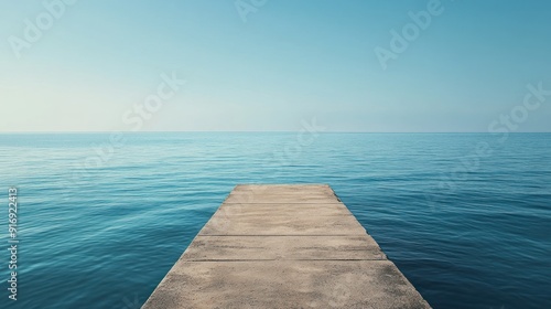 Concrete Pier Extending Into Tranquil Blue Sea