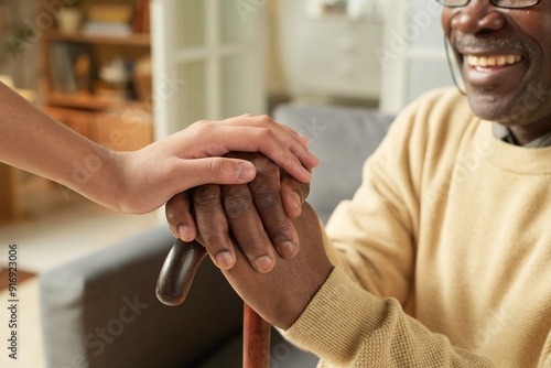 Bild auf Leinwand Elderly person is holding hands with younger individual, creating emotional conn