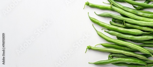 Green beans arranged neatly on a white backdrop, with a space for text or graphics included in the image. image with copy space photo