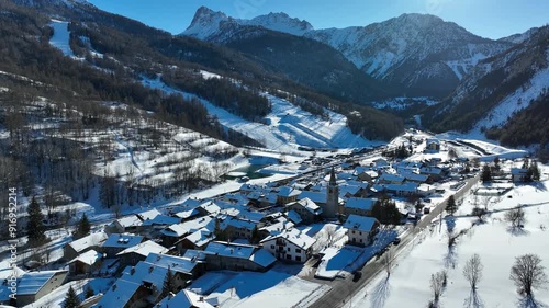 Panoramic view from above at nightfall of the snowy village of Bardonecchia, a ski resort in the Alps in Piedmont, Italy. photo