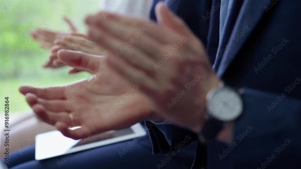 Diverse business team clapping hands while sitting at conference or meeting. Business people applauding with close up of hands Diverse business team clapping hands while sitting at conference or meeting. Business people applauding with close up of hands