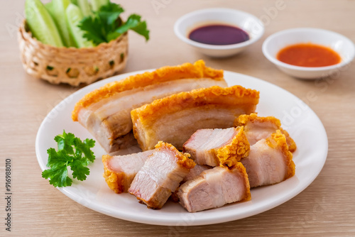 Crispy pork belly on white plate and dipping sauce