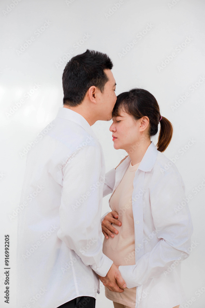 Pregnant woman happy with husband at home, space for text