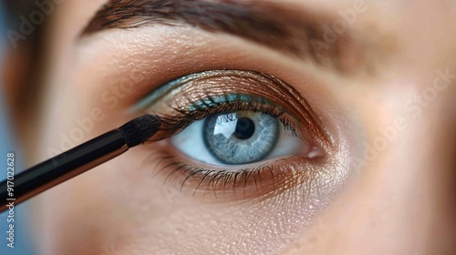 A makeup artist blending eyeshadow on a model eyelid