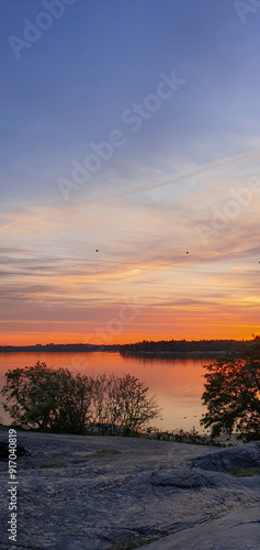 beautiful sunset in orange intensive colors in hietaniemi beach in helsinki finland photo