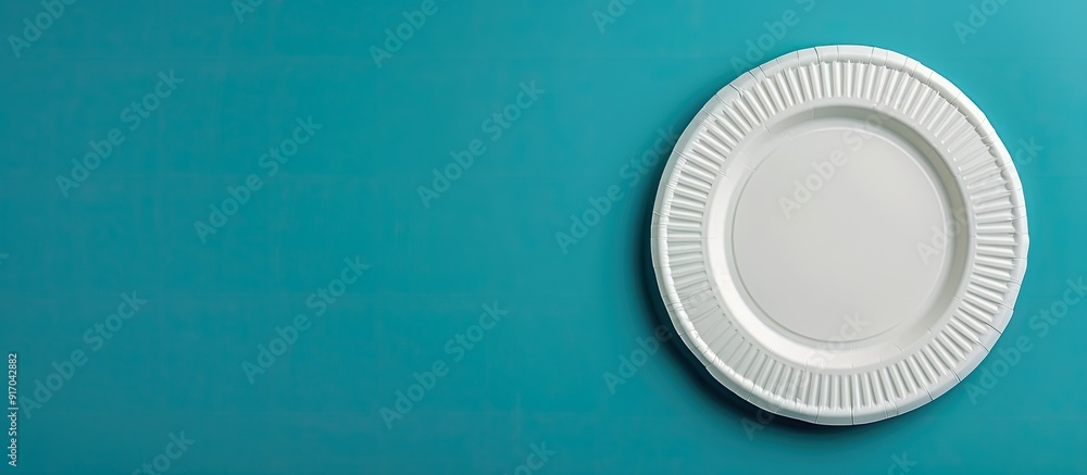 Paper plate attached to blue wall with copy space image Paper plate attached to blue wall with copy space image