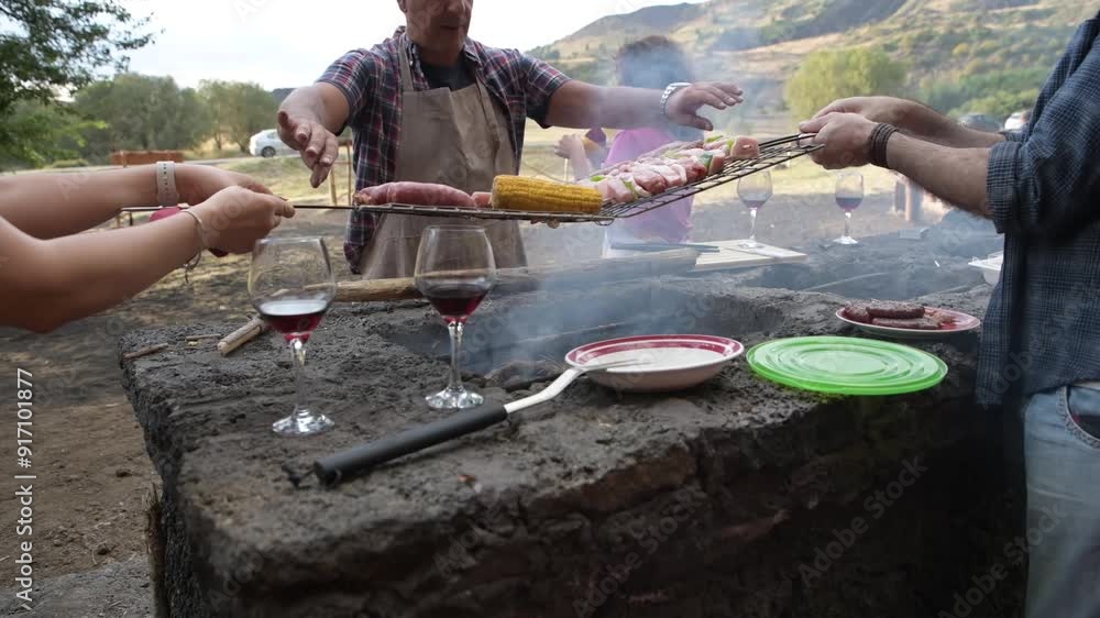 Barbecue party in backyard for meal reunion - Happy multiracial friends making barbecue – man grilling meat on bbq – young people at barbecue grill on patio 