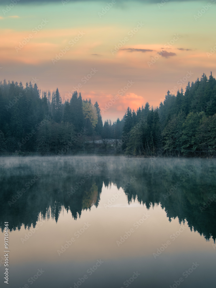 Tranquil morning view of Savsat Karagol Black Lake in Artvin, Turkey, with steam rising from the serene forested waters. Savsat Karagol lake is a large trout lake in the forest in Artvin, Turkey Tranquil morning view of Savsat Karagol Black Lake in Artvin, Turkey, with steam rising from the serene forested waters. Savsat Karagol lake is a large trout lake in the forest in Artvin, Turkey