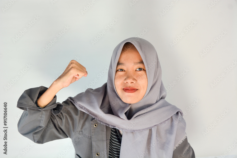 Strong woman in casual clothes smiling over isolated background showing her muscles Strong woman in casual clothes smiling over isolated background showing her muscles
