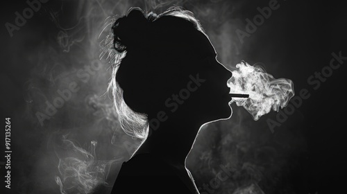 Silhouette of a woman smoking in a dark room photo