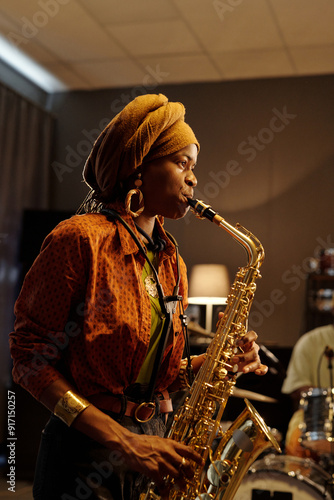 Obraz na plátne Musician performing on saxophone in warm, intimate indoor environment
