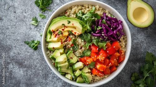 Overhead shot of a fresh and vibrant quinoa bowl with mixed vegetables and avocado