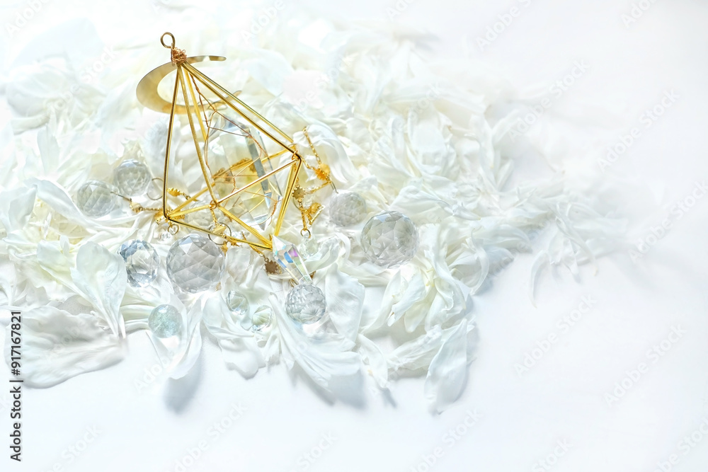 Clear quartz mineral, glass prisms, white flower petals close up on abstract light background. Magic crystal ritual, esoteric practice for positive spirit, harmony, productive the mind, meditation Clear quartz mineral, glass prisms, white flower petals close up on abstract light background. Magic crystal ritual, esoteric practice for positive spirit, harmony, productive the mind, meditation
