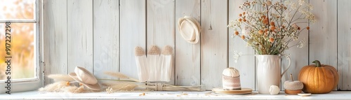 A home entryway with scarecrow decorations, a stack of fall-themed invitations on a table, and scarecrow accessories like gloves and hats