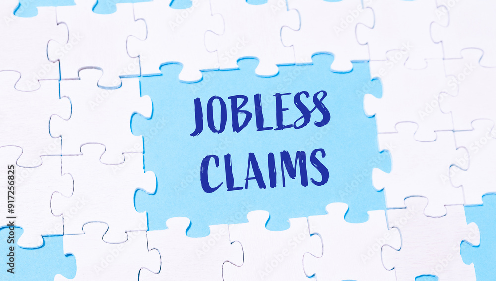 A jigsaw puzzle with the words Jobless Claims written in blue A jigsaw puzzle with the words Jobless Claims written in blue