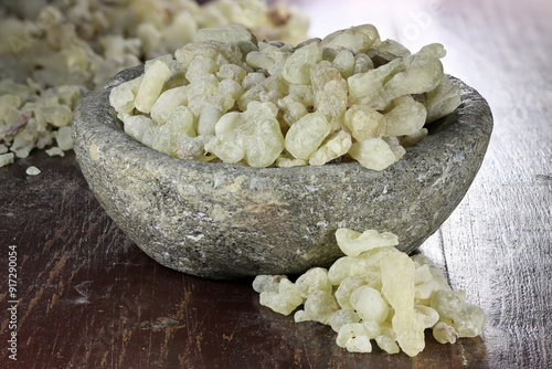 Al-Hojari Boswellia sacra frankincense resin from Oman in a stone bowl on wooden table