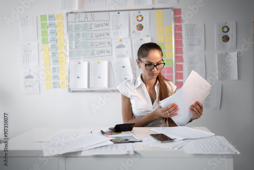 Fotografie Dedicated Female Accountant Preparing Detailed Financial Report