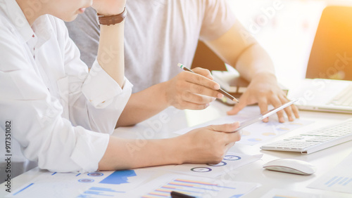 Tableau sur toile Startup entrepreneurs are talking to business consultants to study and calculate feasibility of investing business to get worthwhile return
