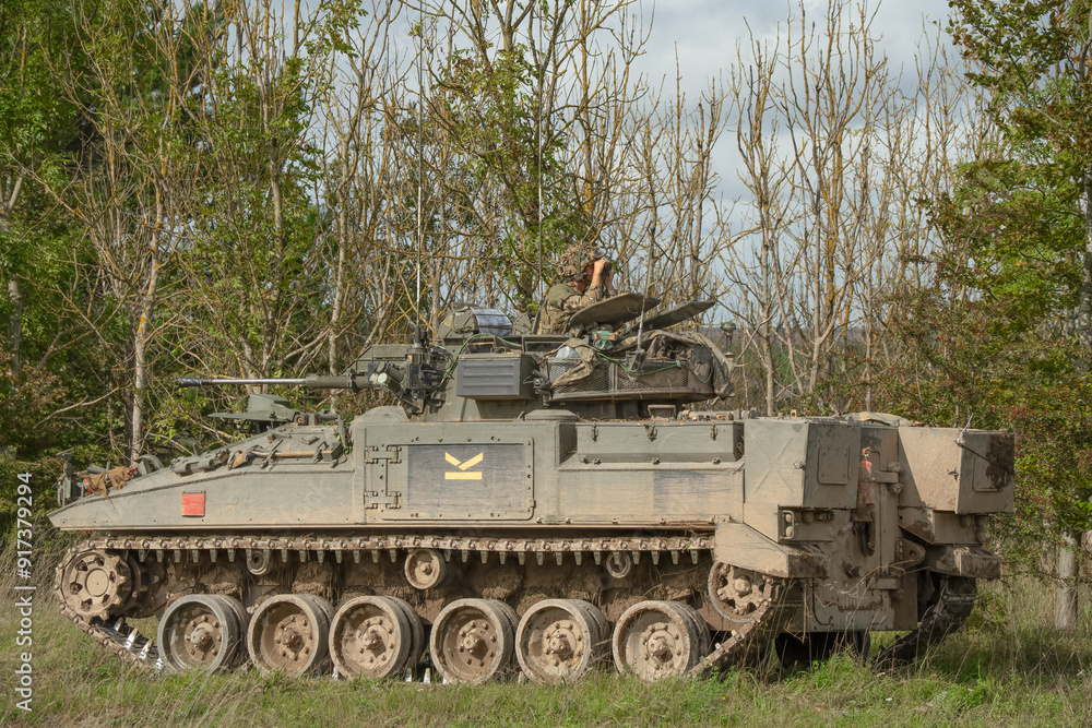 close-up of a soldier in a British army FV510 Warrior Infantry Fighting Vehicle with guns on a battle exercise close-up of a soldier in a British army FV510 Warrior Infantry Fighting Vehicle with guns on a battle exercise