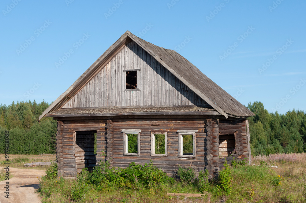 Old abandoned rough log house at forest edge in northern Russia Old abandoned rough log house at forest edge in northern Russia