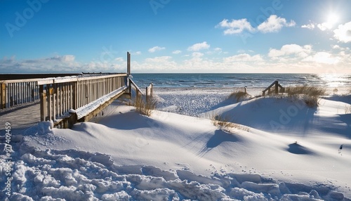 sonniger wintertag am meer strandzugang und alter steg an der ostsee photo