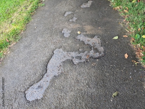 Potholes in a badly maintained asphalt path