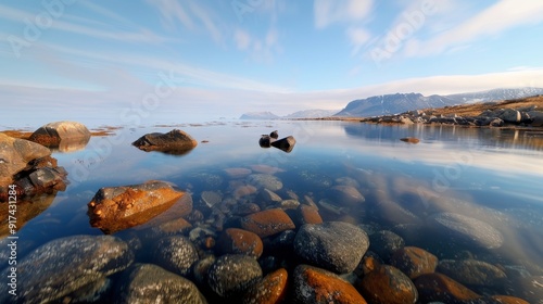Tranquil Waters Reflecting Mountains and Colorful Stones at Twilight