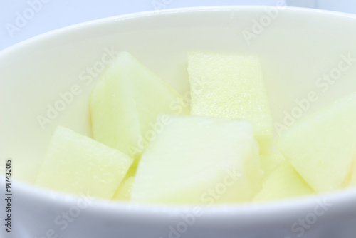 peeled melon in bowl. sliced ​​melon in bowl. green natural food. melon with selective focus.