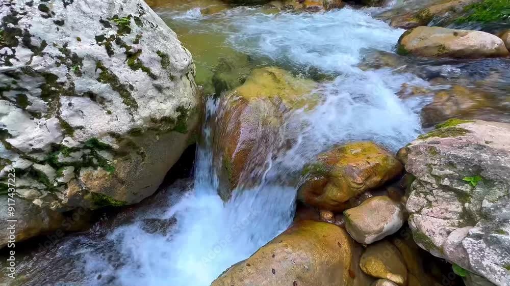 The waterfall, the river washing rocks, the stream of a mountain river. The waterfall, the river washing rocks, the stream of a mountain river.
