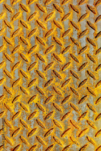 Textured Background of a Rusty Corrugated Metal Sheet With a Diamond Pattern, Giving an Industrial Feel