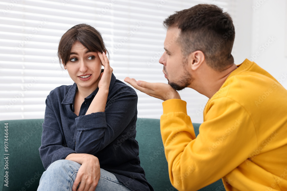 Man sending air kiss to embarrassed woman at home Man sending air kiss to embarrassed woman at home