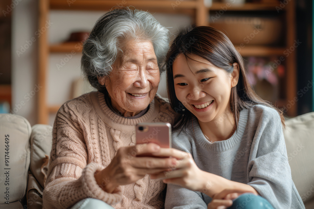 Asian Mother and Daughter Sharing a Moment on Mobile Asian Mother and Daughter Sharing a Moment on Mobile