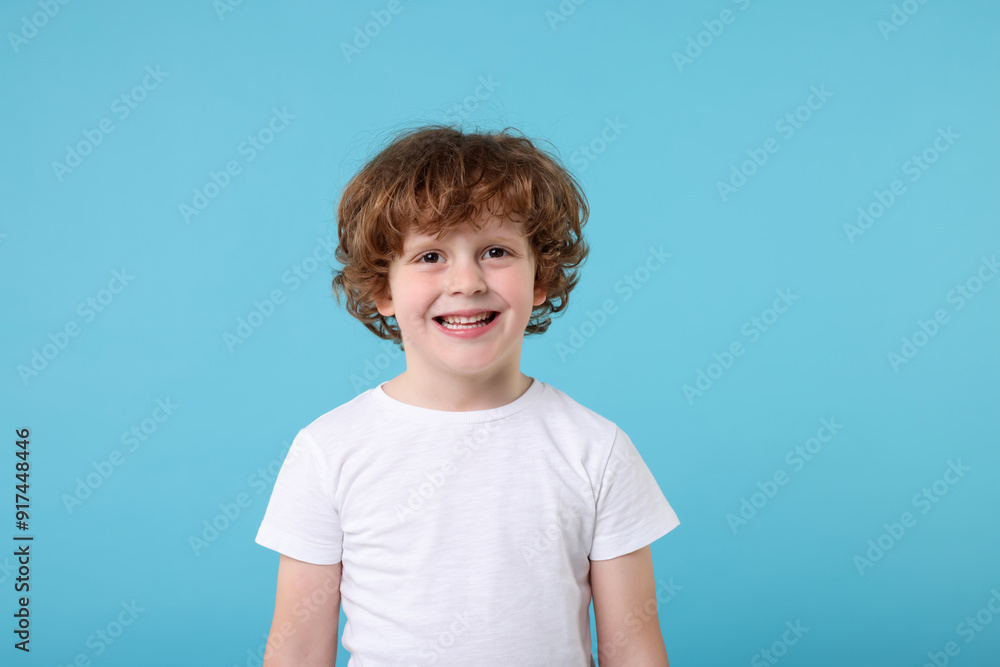 Portrait of cute little boy on light blue background Portrait of cute little boy on light blue background