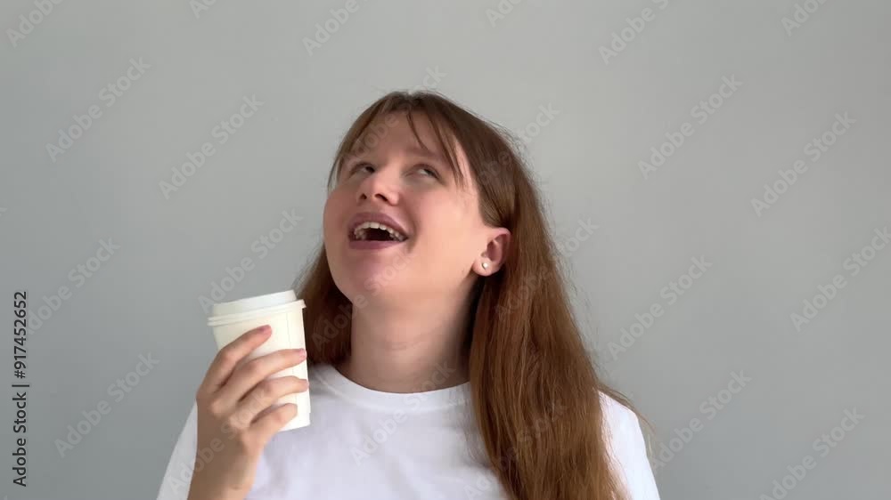 Happy young woman is drinking cup of coffee and having fun Happy young woman is drinking cup of coffee and having fun