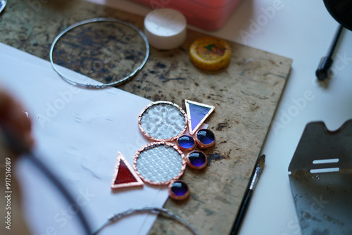 Stained glass workshop. Table with pieces of glass and necessary tools.  photo