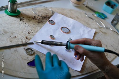 Stained glass workshop. Table with pieces of glass and necessary tools.  photo