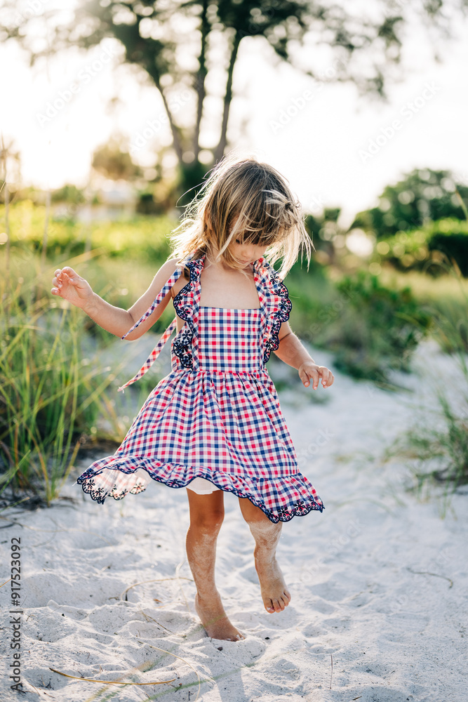 little girl in a dress on the beach