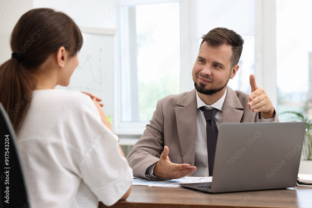 Consultant working with client at table in office. Business meeting Consultant working with client at table in office. Business meeting