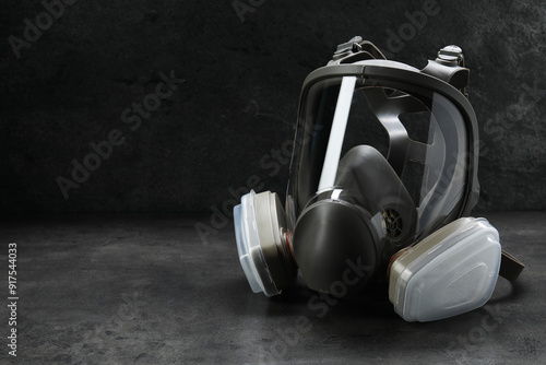 Photos One full face respirator on dark background. Space for text